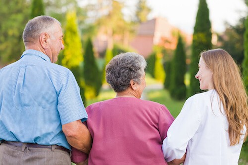 Senior couple with their daughter about to tour a senior living community