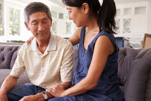 Caregiver daughter helping her senior father and avoiding caregiver burnout