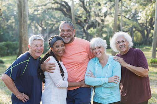 A group of independent seniors enjoy friends at a park