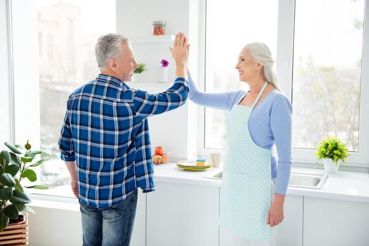 A senior couple uses life hacks to do chores