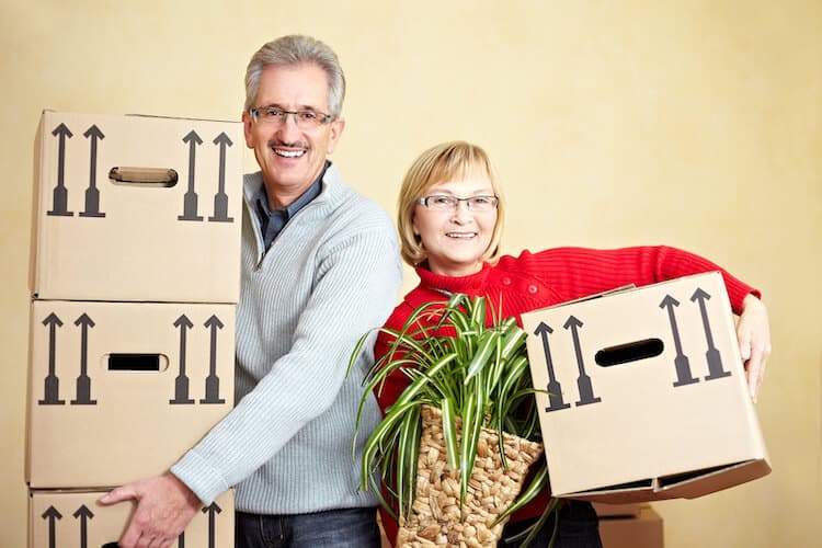 A senior couple packs boxes for a move