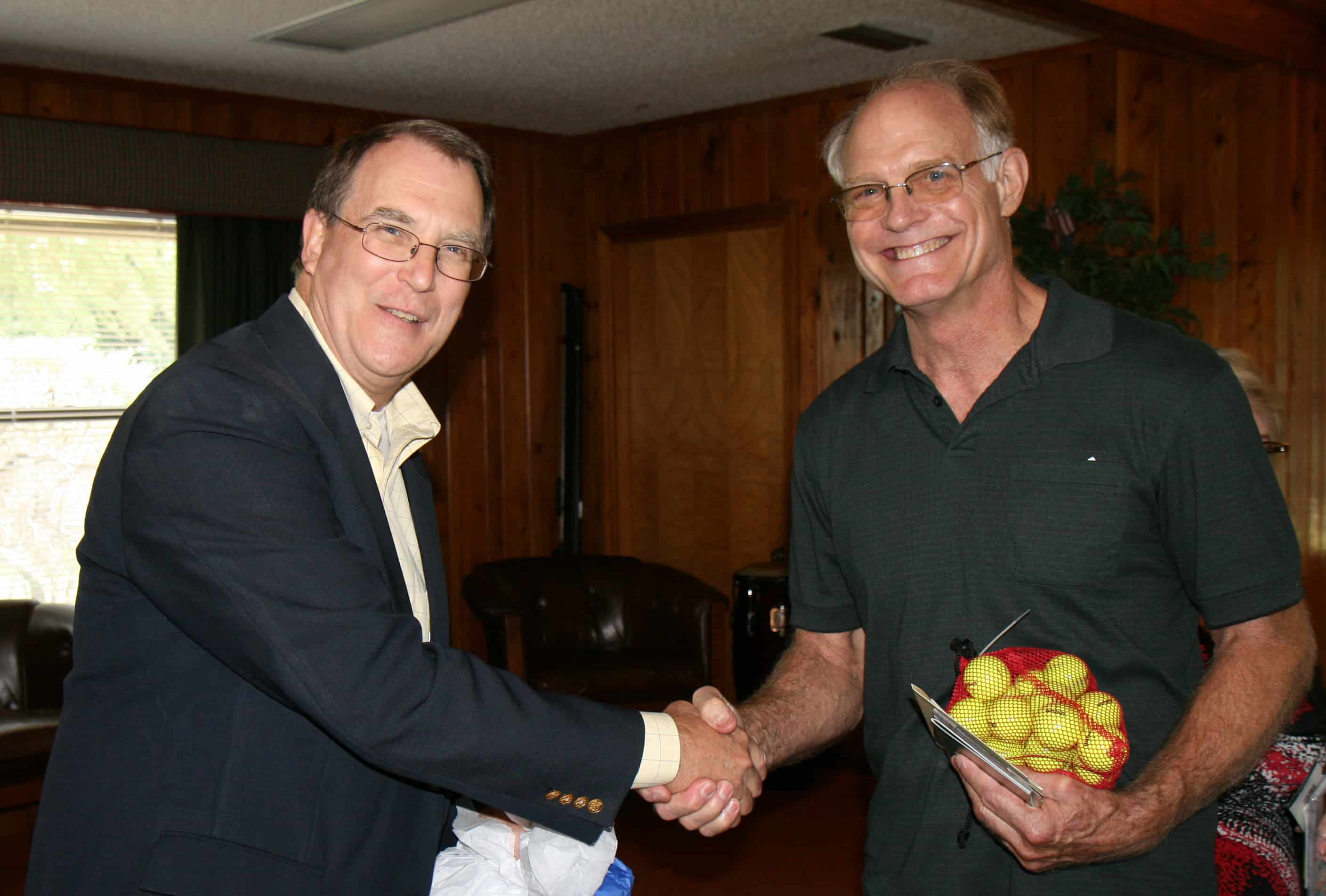 Wayne Hinrichs shaking hands during his retirement party