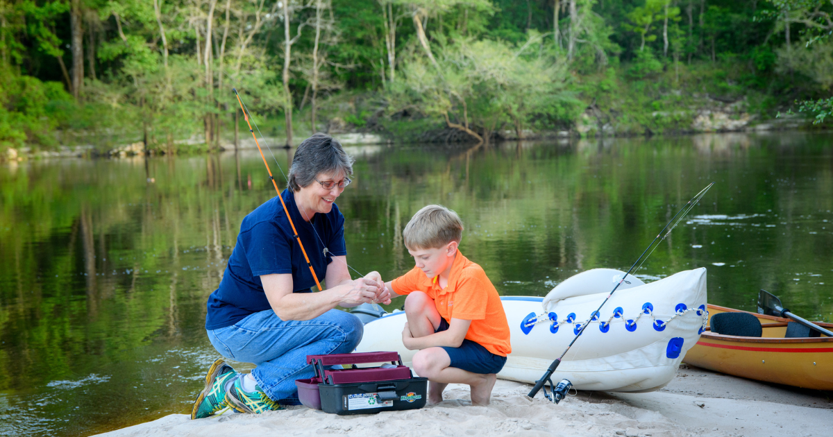 A grandmother and her grandson enjoy fishing on the lake in this picture of small town retirement life.