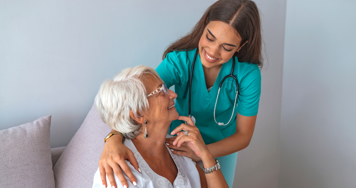 A smiling senior woman with her nurse at home.